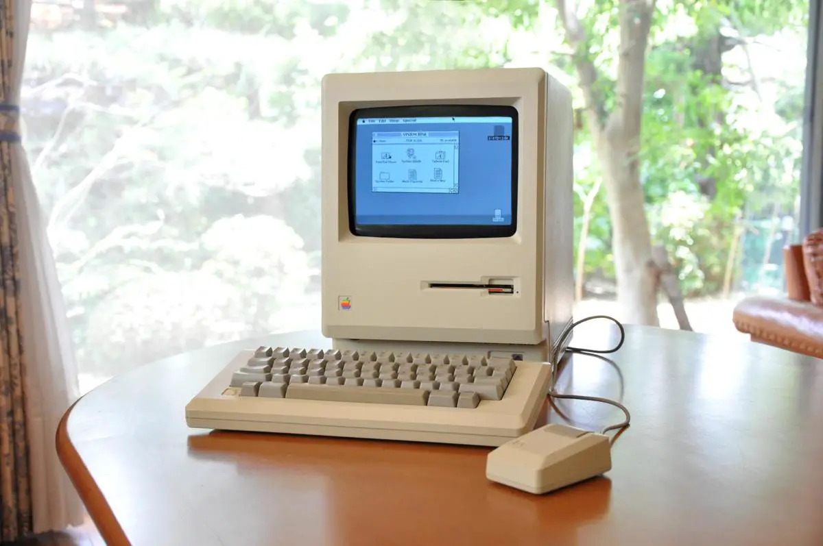 A collection of revolutionary Apple products including the original Macintosh, iPod, iPhone, iPad, and Apple Watch