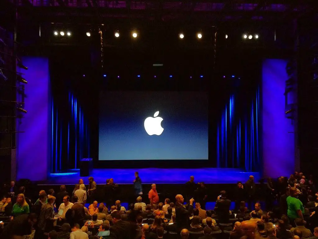 An exciting Apple product launch event with an enthusiastic audience