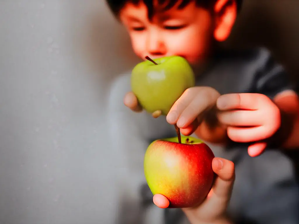 A person with braces holding an apple, but with a line through them to represent that they shouldn't bite directly into the apple