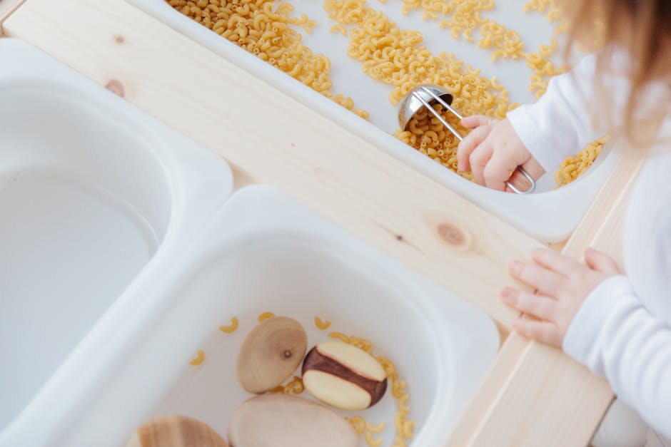 Image of a child happily mixing ingredients in a bowl while making a recipe with apples.